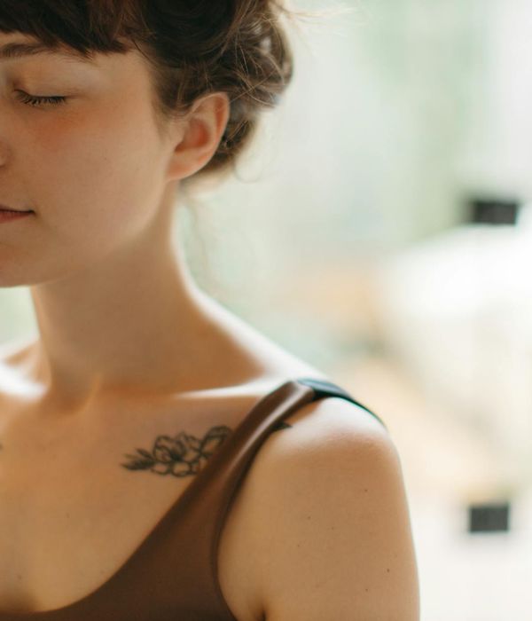 Woman performing a gentle yoga pose in a calm environment.